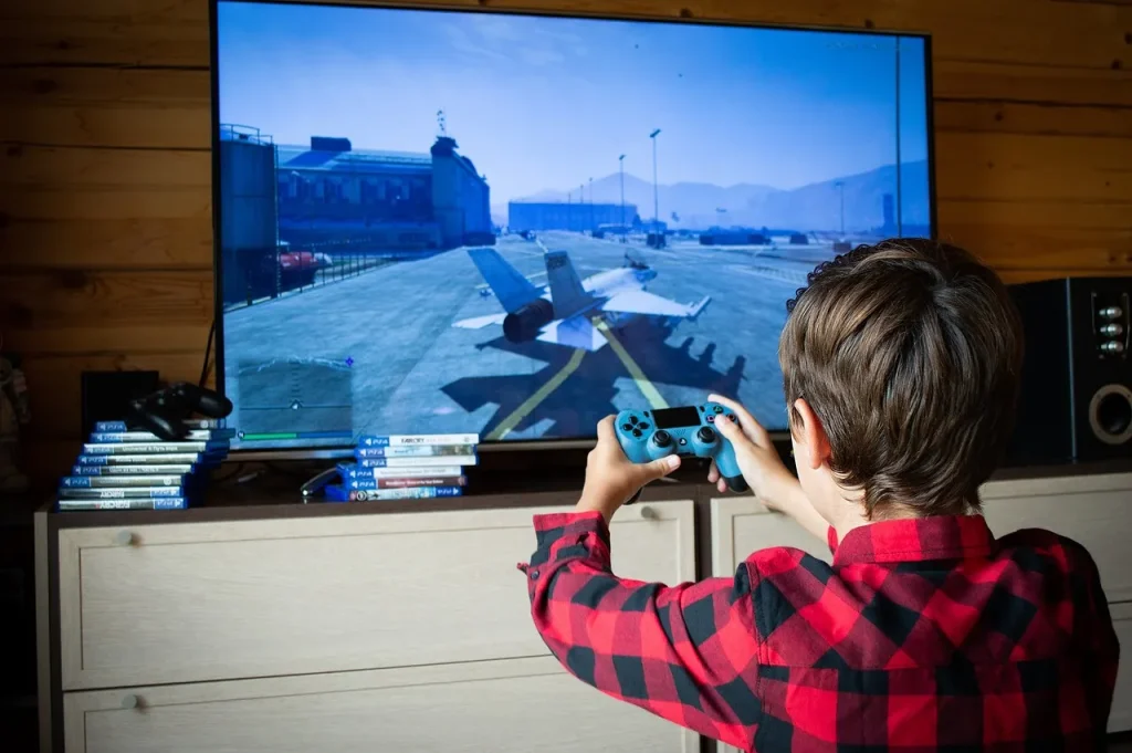 Chłopiec gra na padzie na playstation